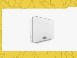 Technical specialist setting up MTN FibreX router connection in a Lagos home office.