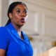 **Kemi Badenoch Facebook page owner speaking at a podium during a public event**
